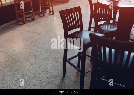 Empty cafe. Wooden chairs beside bar counter. Seats in circle Stock Photo