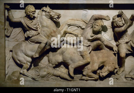 Sarcophagus of Alexander the Great (late 4th century BC). It was found in the royal necropolis of Sidon (Sayda). Pentelic marble. High relief of one of the lateral sides. Detail depicting a battle between Greeks and Persians (with long pants, anaxyrides). On the left, Alexander the Great, with the skin of the head of Lion of Nemesis, chasing a Persian soldier. Archaeological Museum. Istanbul, Turkey. Stock Photo