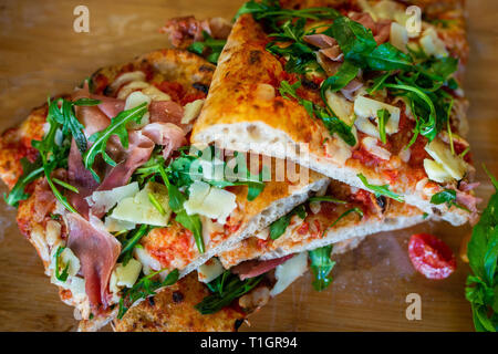 Wood fired pizza. traditional wood fired roman style Italian pizza slices in a pizzeria trattoria restaurant. Pizza romana Stock Photo