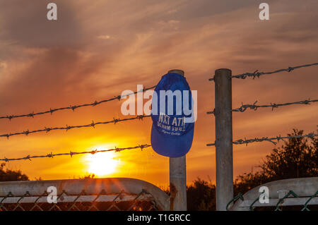 Cap on barbed wire fence Stock Photo