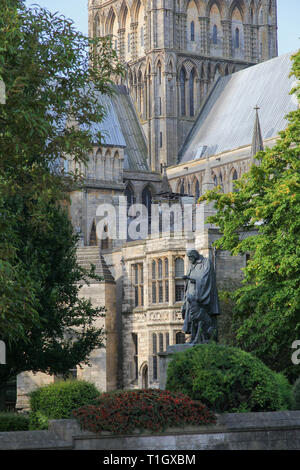 Lincoln Cathedral alternate viewpoint between trees, Northgate outside Lincoln Hotel. Lord Alfred Tennyson statue in garden. Famous Yellowbelly, Stock Photo