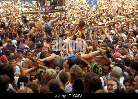 Concert fans are shown crowd surfing during Woodstock 94 in Saugerties, New York. Stock Photo