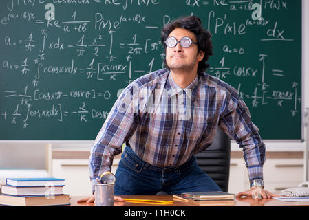 Funny male math teacher in the classroom Stock Photo