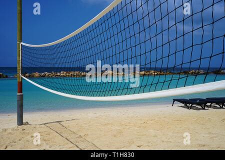 Beach volleyball net with a blue sea on the background Stock Photo