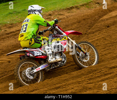 British motocross championship racing at Cadders Hill, Lyng, Norfolk. Honda rider carefully negotiating the ruts and troughs carved in to the circuit  Stock Photo