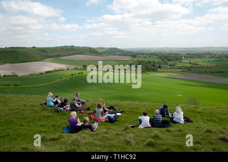 Rear view of a group of walkers sitting and picnicking having a rest Stock Photo