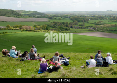 Rear view of a group of walkers sitting and picnicking having a rest Stock Photo