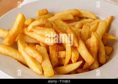 White plate of french fries in a restaurant Stock Photo