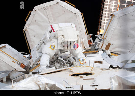 Expedition 59 NASA astronauts Anne McClain works upgrading the power supply during a spacewalk outside the International Space Station March 22, 2019 in Earth Orbit. Astronauts McClain and Hague spent six-hours and 39-minutes outside the space station to upgrade the orbital complex's power storage capacity. Stock Photo