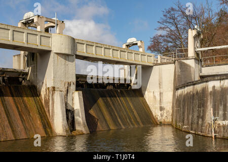 A water dam on a small river. Hydrotechnical construction for leveling water during the poison. Season of the spring. Stock Photo