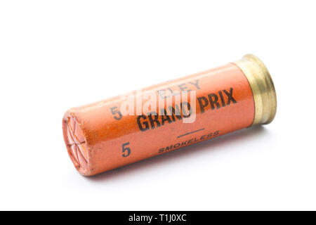 A paper case Eley Grand Prix 12 gauge, or bore, shotgun cartridge with a crimp closure loaded with No 5 lead shot pellets. Collecting shotgun cartridg Stock Photo