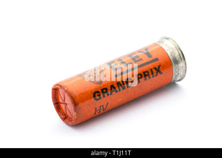 A paper case Eley Grand Prix 12 gauge, or bore, shotgun cartridge with a crimp closure loaded with lead shot pellets. Collecting shotgun cartridges is Stock Photo