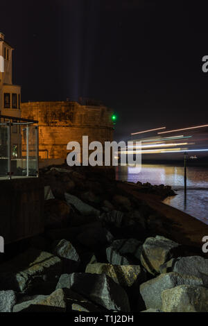 Ferry light trails passing the round tower in Portsmouth harbour entrance Stock Photo