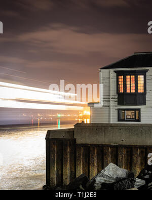 Ferry light trails passing Portsmouth harbour entrance Stock Photo