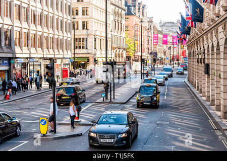 London, UK - June 22, 2018: High angle view of Piccadilly Circus Regent street with cars taxi cabs black on street traffic on road with banners hangin Stock Photo