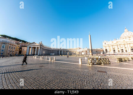 Vatican City, Italy - September 5, 2018: Emtpty St Peter's Square Basilica during sunny day architecture with one priest walking and Rome panoramic vi Stock Photo