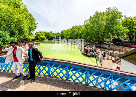 London, UK - June 24, 2018: Neighborhood district of Little Venice Italy canal traditional style boats during sunny summer day and people on bridge Stock Photo