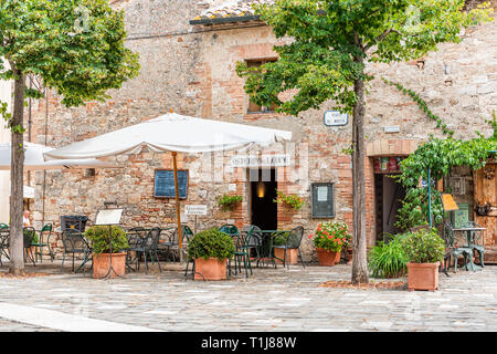 Bagno Vignoni, Italy - August 26, 2018: Medieval town by San Quirico d'Orcia in Val d'Orcia, Tuscany with empty street historical buildings and osteri Stock Photo