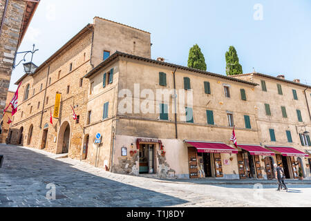 Montalcino, Italy - August 26, 2018: Street steep in town village in Tuscany during summer day and wine store with local Brunello Stock Photo