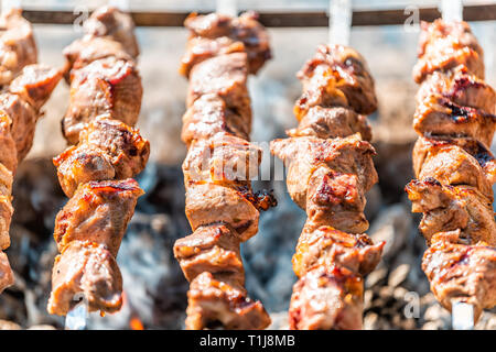 Shish kebab of meat skewered on a grill close-up outdoors Stock Photo -  Alamy