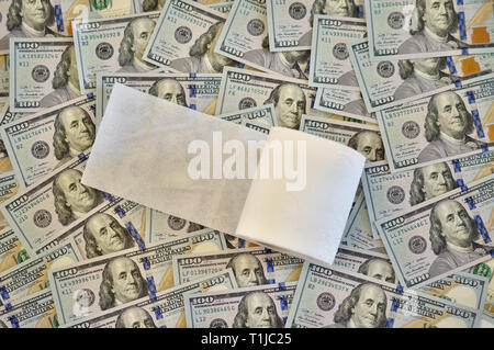 roll of toilet paper on the background of dollar bills Stock Photo