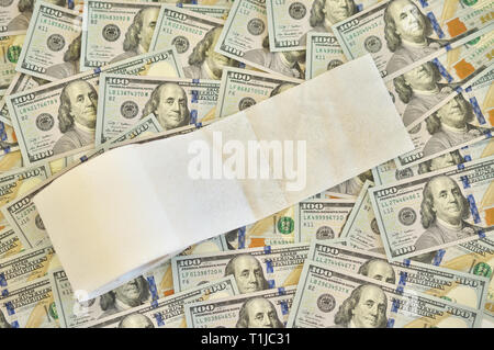 roll of toilet paper on the background of dollar bills Stock Photo