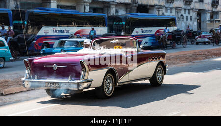 Havana, Cuba - 25 July 2018: A vintage 1950s Buick Century with exhaust fumes coming out of the back is being used as a taxi in Havana Cuba. Stock Photo