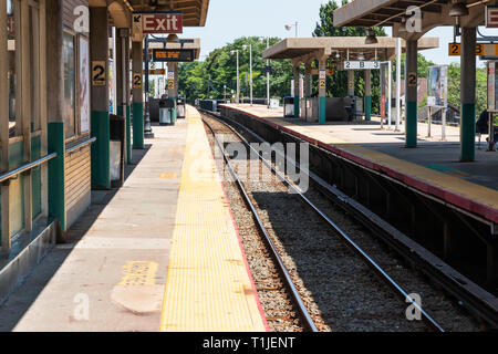 Babylon, New York, USA - 14 August 2018: Babylon Railroad station platform looking west down the tracks. Stock Photo