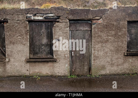 Exterior shots of crumbling grey rough cast wall in and around the royal burgh of Wick harbour caithness scotland Stock Photo
