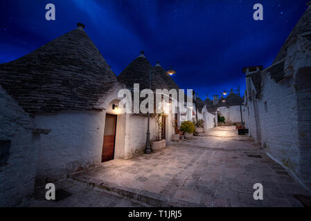 Night view of Alberobello's famous Trulli, the characteristic cone-roofed white houses of the Itria Valley, Apulia. ALBEROBELLO, PUGLIA, ITALY Stock Photo