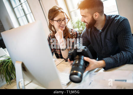 Two young designers working in modern office Stock Photo