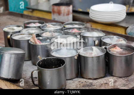 Boiling pots with lamb meat. Captured at a market in Kashgar (Xinjiang Province, China). Stock Photo