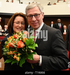 Bremen, Germany. 27th Mar, 2019. Carsten Sieling (SPD), Mayor, congratulates Antje Grotheer (SPD), the new and first President of the Landtag, with a bouquet of flowers. The Bremen parliament has elected the SPD member of parliament to succeed Christian Weber (SPD), the long-time president of the state parliament, who died in February. Credit: Carmen Jaspersen/dpa/Alamy Live News Stock Photo