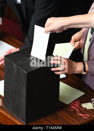 Bremen, Germany. 27th Mar, 2019. A member of the Bremen Parliament shoves his ballot paper into the urn. The Bremen parliament has elected the SPD member of parliament to succeed Christian Weber (SPD), the long-time president of the state parliament, who died in February. Credit: Carmen Jaspersen/dpa/Alamy Live News Stock Photo