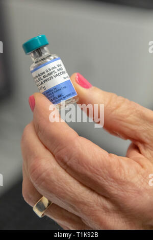 Southfield, Michigan, USA. 27th Mar, 2019. A nurse holds a vial of the MMR vaccine at the Oakland County Health Department, which protects against measles, mumps, and rubella. The health department is urging vaccinations since 22 measles cases have been confirmed following the visit of an infected traveler from Israel. Credit: Jim West/Alamy Live News Stock Photo