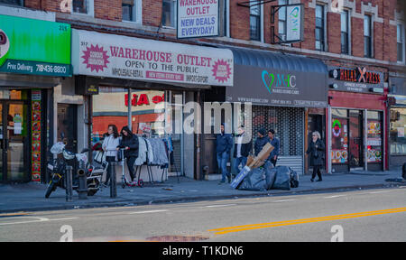 Young people walking through the streets of Pakistani neighborhood in Brooklyn. Stock Photo