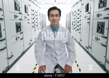 Technical personnel in the voltage room work Stock Photo
