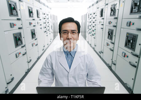 Technical personnel in the voltage room work Stock Photo
