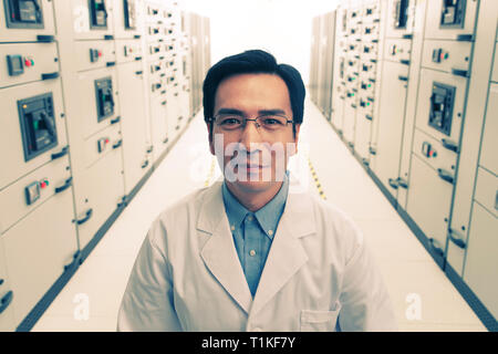 Technical personnel in the voltage room work Stock Photo