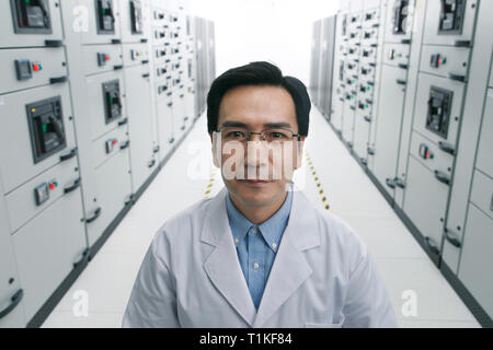 Technical personnel in the voltage room work Stock Photo