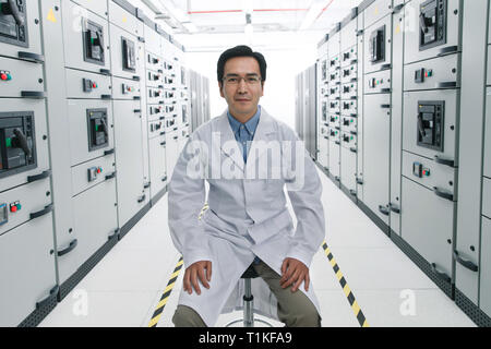 Technical personnel in the voltage room work Stock Photo
