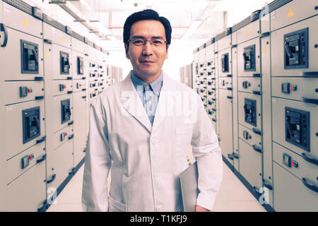 Technical personnel in the voltage room work Stock Photo