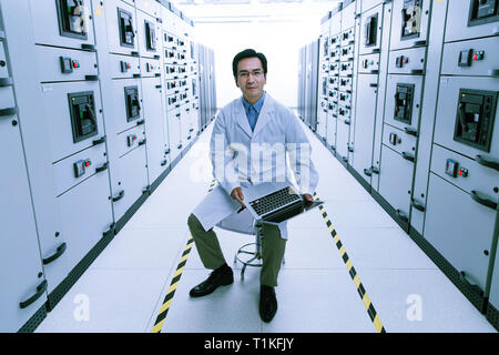 Technical personnel in the voltage room work Stock Photo