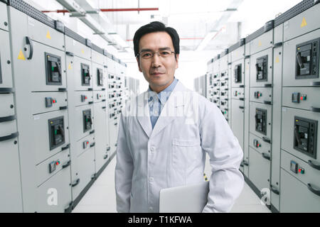 Technical personnel in the voltage room work Stock Photo