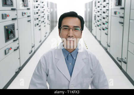 Technical personnel in the voltage room work Stock Photo