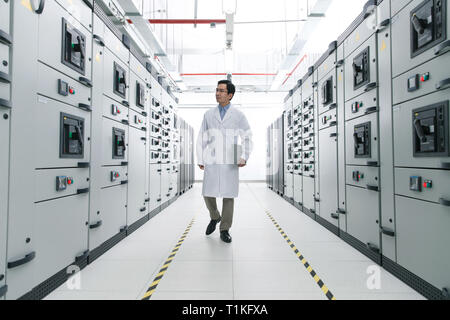 Technical personnel in the voltage room work Stock Photo