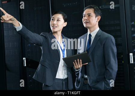 Technical personnel in machine room inspection Stock Photo