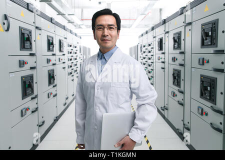 Technical personnel in the voltage room work Stock Photo
