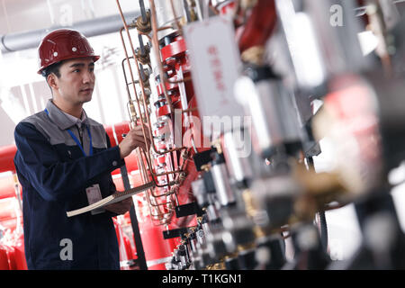 Technical personnel in the factory fire control room inspection Stock Photo