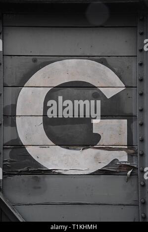A rustic and peeling painted letter G on the side of a Great Western Railway goods van at Bewdley Worcestershire on the Severn Valley Heritage Railway Stock Photo
